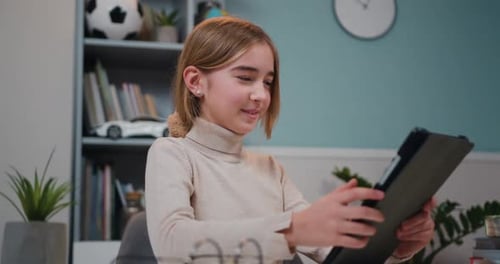 Smiling Child Using Tablet Computer at Home