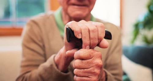 Senior Man Holding Black Cane Inside