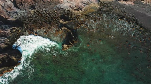 Wild Volcanic Calm Ocean Beach Waves Crashing on Sand and Stones Rocky Shore