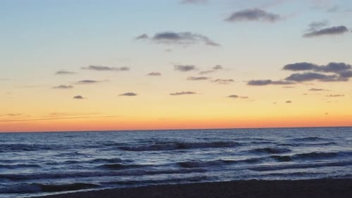 Sunset on the sea, empty sandy beach