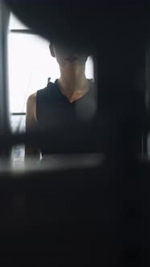 Attractive Young Athlete is Seen Training in Gym Doing Exercises to Strengthen Her Back Muscles With