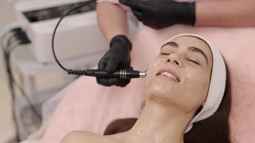 Woman Receiving Electric Facial at a Spa