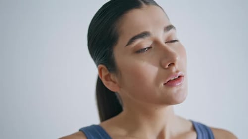 Woman with Slicked Back Hair Doing Neck Stretches