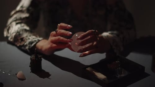 Woman Holding Crystal Ball With Various Stones