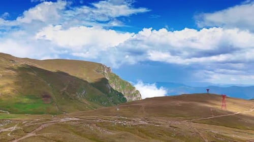 Hills of Bucegi Mountains under blue sky. Wide view of rolling hills in the Bucegi Mountains