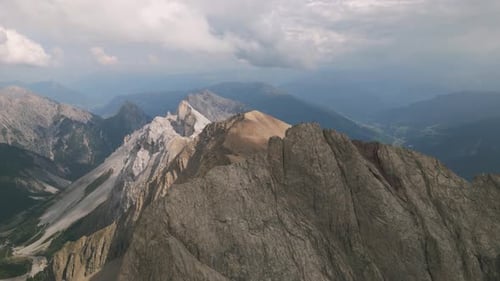 Majestic Alpine Mountain Peak at Sunrise with Dramatic Skies