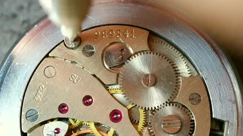 Watchmaker Tightening Screw on Vintage Watch Mechanism