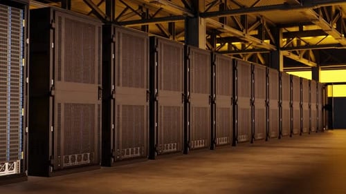 Row of black server racks in industrial data center with yellow lighting and exposed ceiling. Cloud