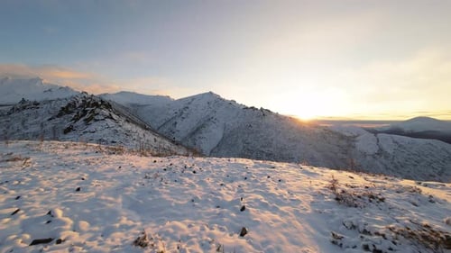 Sunrise over Snowy Mountain Range in Winter