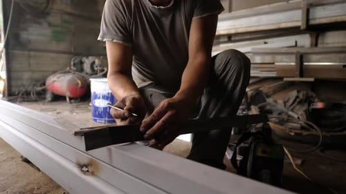 Male Arms of Professional Repairman Measuring Metal Detail with Plastic Ruler at Garage Young Male