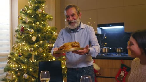 Family Gathering Around Christmas Dinner with Festive Turkey