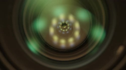 camera lens on a black background, macro zoom. Dolly slider extreme close-up.