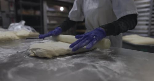Baker Preparing Rolling Bread Dough in Bakery Kitchen 10 Seconds or Greater