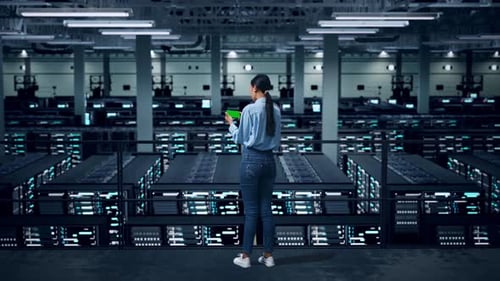 Back View Of Full Body Asian Business Woman Using Mobile Phone With Green Screen In Data Center