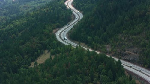 Oregon i5 freeway winding over mountain pass filmed from helicopter circa 2021