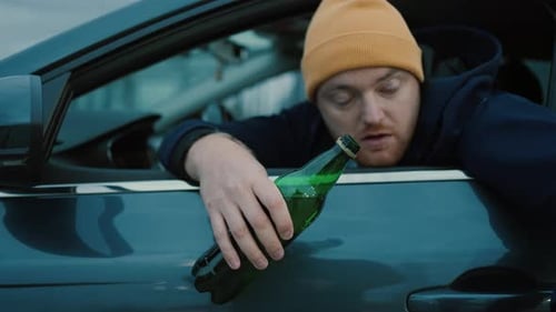 Drunken Driving Risk Car AccidentMan Holding Alcohol Bottle In Car Dangerous On Road Drunk