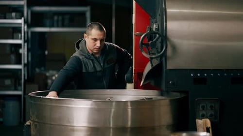 Coffee Holder in a Roasting Factory Checking the Roast Level of the Coffee Ready to Drink