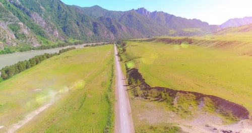 Aerial Rural Mountain Road and Meadow at Sunny Summer Morning Asphalt Highway and River