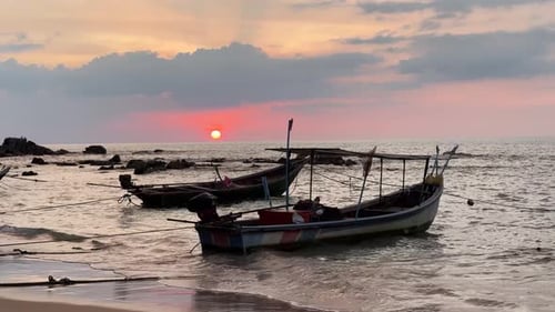 Fishing Boats Resting on Beach at Sunset