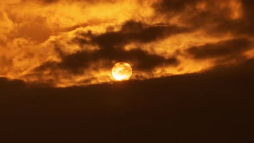 Sunset over a mountain in the orange sky 4k time lapse video.