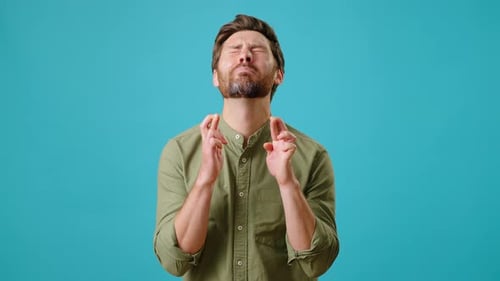 Man Pleads and Crosses Fingers for Good Luck