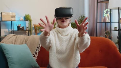Woman Uses VR Headset on Orange Couch Indoors