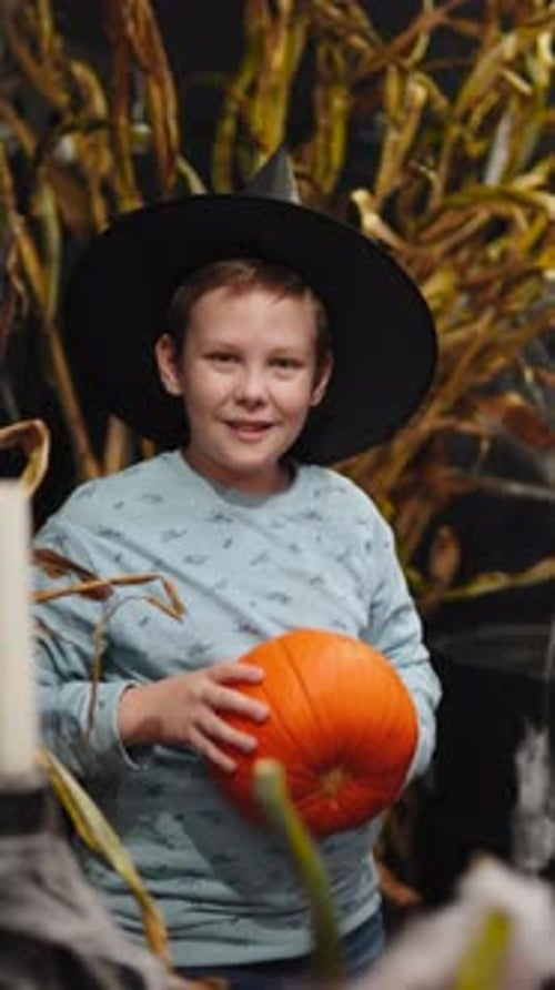 Happy Boy Holding Pumpkin Wearing Halloween Hat