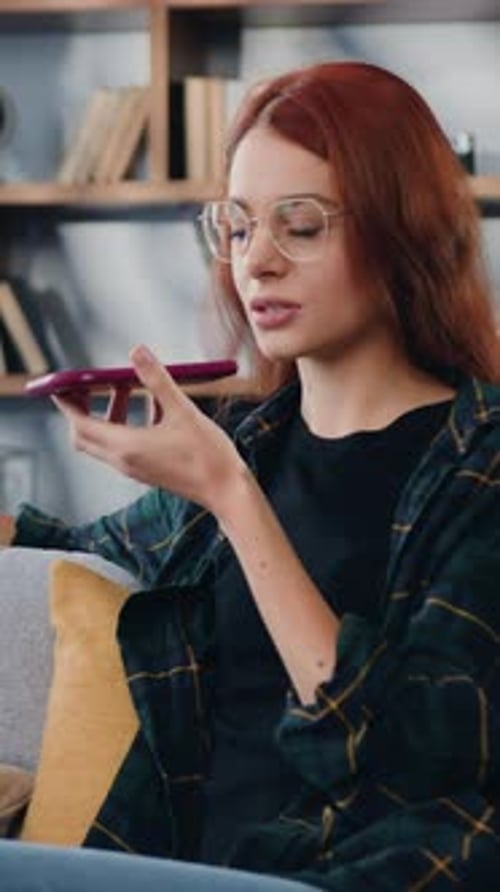 Woman Chatting Via Smartphone Voice Message Indoors