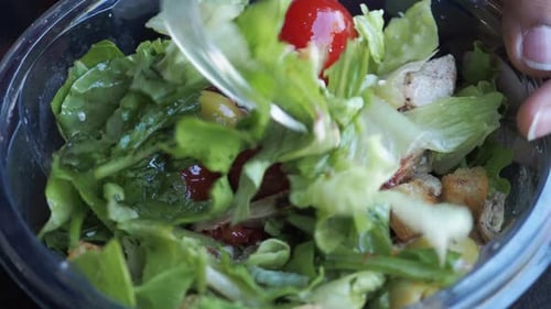 Women Eating Salad in a Plastic Bowl Outdoor