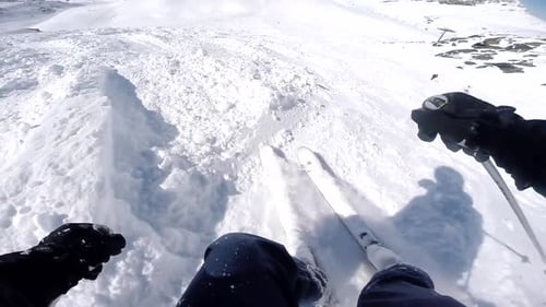 PoV of man skiing off-piste down challenging slope with heavy snow in France, Val Thorens