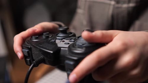 Hands Playing Video Game with Black Controller