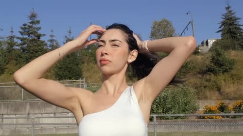 Portrait of Sporty Girl Tying Up Her Hair - Close Up Parallax