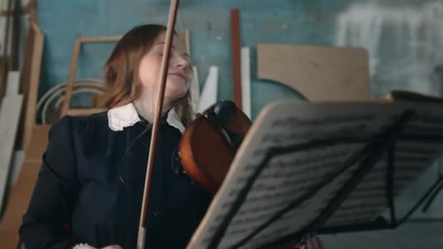 Woman Plays Violin With Bow Indoors