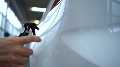 Spraying Water on Side of White Car