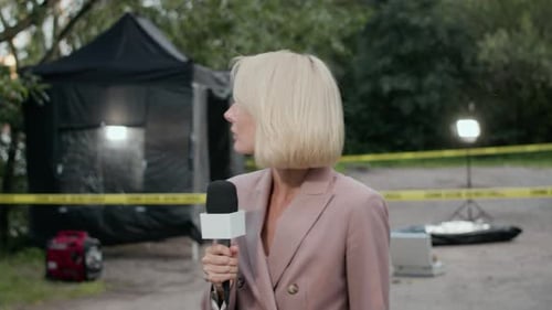 Female Crime Reporter Presenting News at Crime Scene