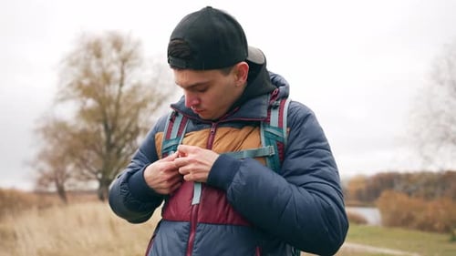 Portrait facial d'un beau jeune homme caucasien qui se promène dans un paysage naturel d'automne contre un lac ou