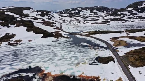 Aerial view of road and snow covered hills, Norway.
