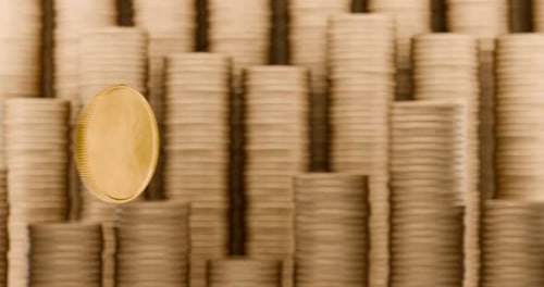 Golden Coin Spinning and Focusing on Stacked Coins Background