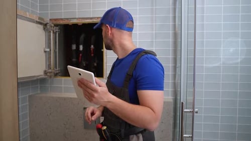 Male Plumber Checks Pipes for Central Hot and Cold Water Supply of Apartment Male Plumber Performs