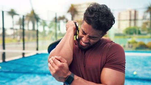 Frustrated man, padel and sport injury with elbow for pain, ache or joint inflammation in court