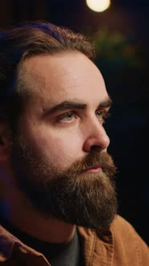 Man with Beard in Profile Thinks, Drinks Coffee