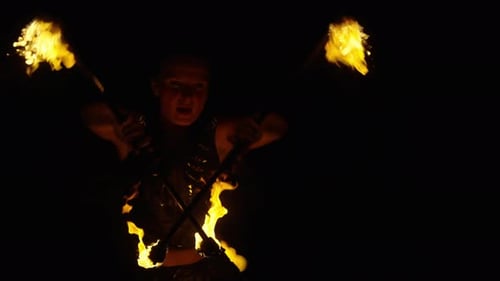 Woman Performs Fire Dance with Flaming Torches