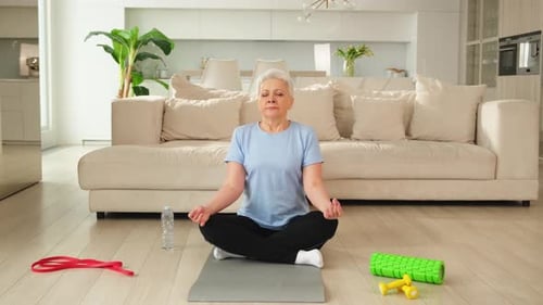 Senior Woman Meditating in Modern Living Room
