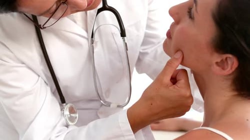 Dermatologist examining a patients face