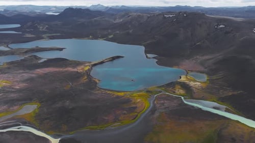Aerial View of Iceland's Volcanic Terrain with Turquoise Lake