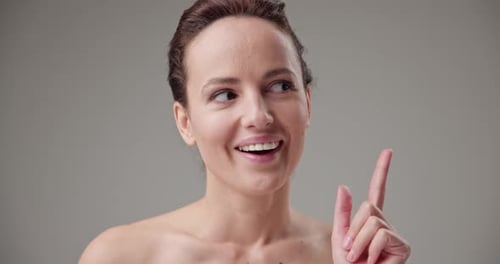Woman Posing and Smiling on Gray Background