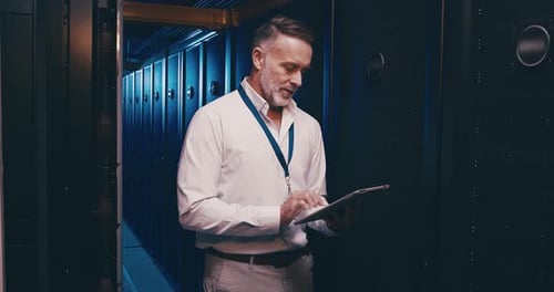 Man Using Tablet in Server Room