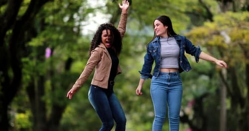 Enthusiastic fun girls jumping in the air