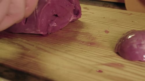 Close-up: Raw pig heart cut into strips on wooden chopping block