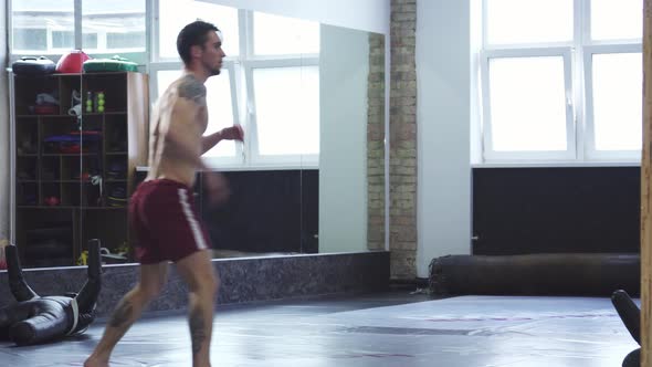 Dynamic MMA Fighter Executing a Powerful Spinning High Kick in the Gym ...
